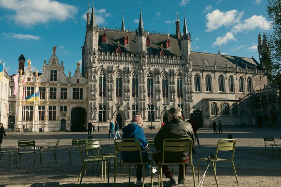 Locals sitting on Burg Square in Bruges on a sunny day