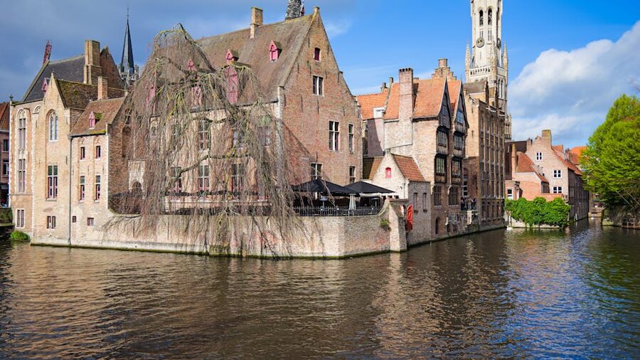 Bruges canal with the Belfry tower in the background