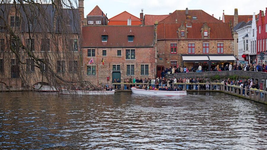 Bruges canal cruise boat passing through medieval city