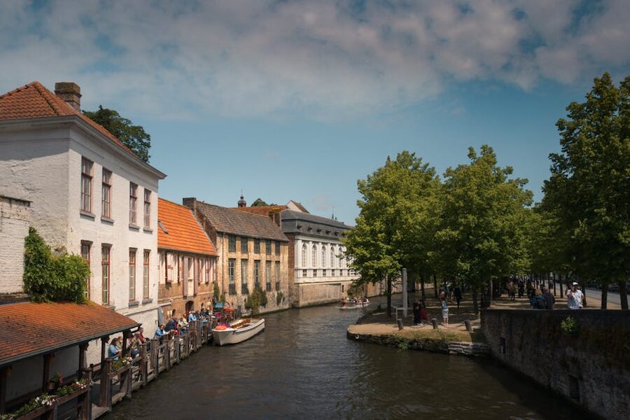 Bruges canal lined with historic Flemish buildings on a sunny day