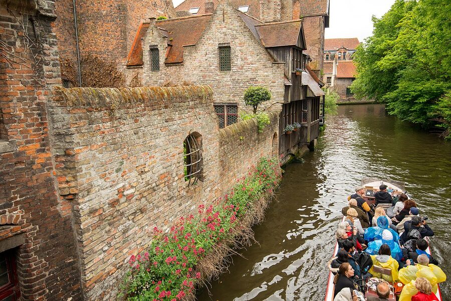 Tour boat with passengers on a Bruges canal