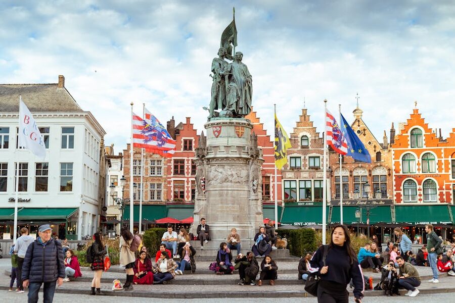 Markt square statue and flags Bruges