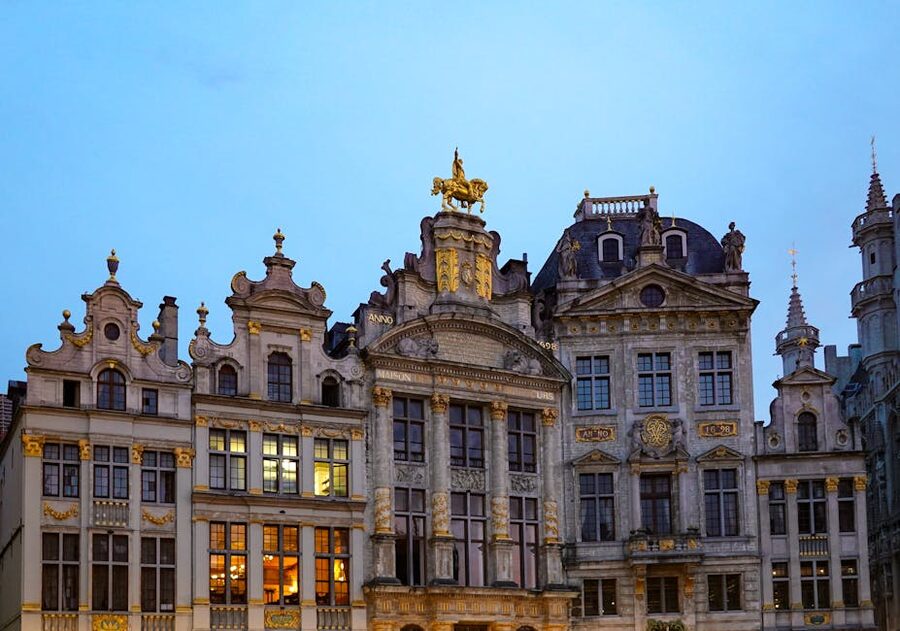 Ornate facades of guildhouses at Grand Place Brussels at twilight