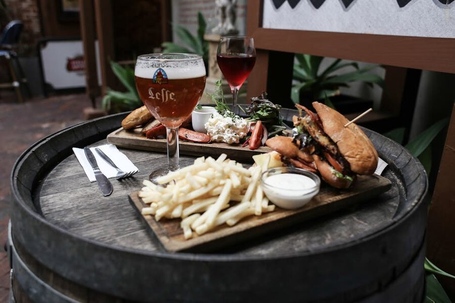 Belgian meal with beer on a rustic barrel table