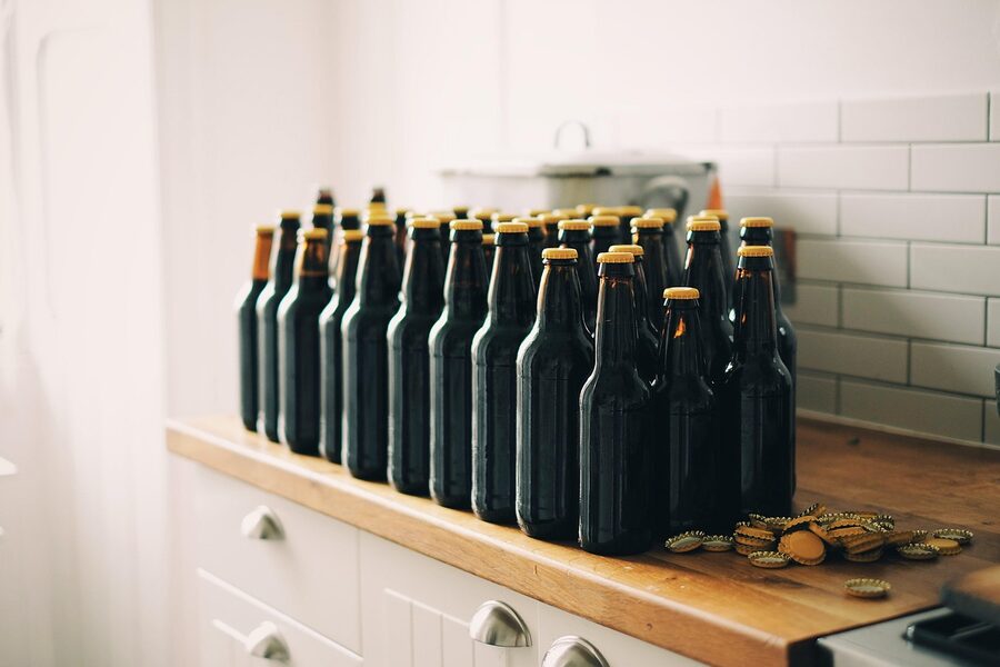 Vintage beer bottles and bottle caps on a Brussels bar shelf