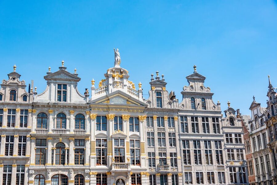 Historic facades at Grand Place Brussels under blue sky