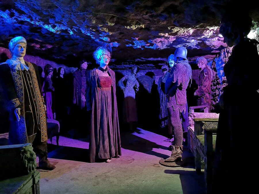 Lit corridor in the Buda Castle Labyrinth showing limestone walls