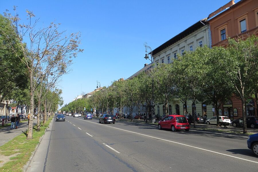 Andrássy út boulevard in Budapest with classical apartment blocks and tree-lined pavement