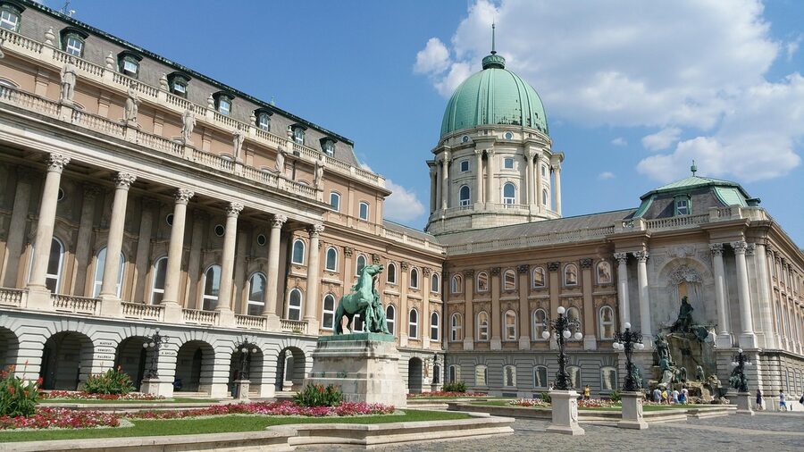 Buda Castle illuminated in the evening seen from across the Danube
