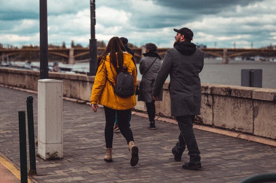 Couple walking on Budapest riverside promenade in autumn