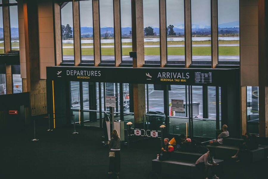 Busy airport terminal with departures and arrivals signs