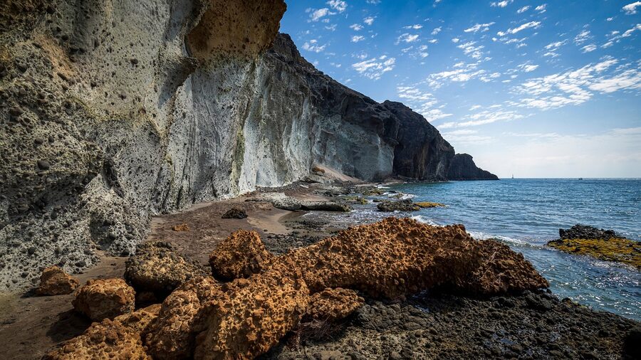 Beach with dramatic cliff backdrop inside Cabo de Gata Natural Park