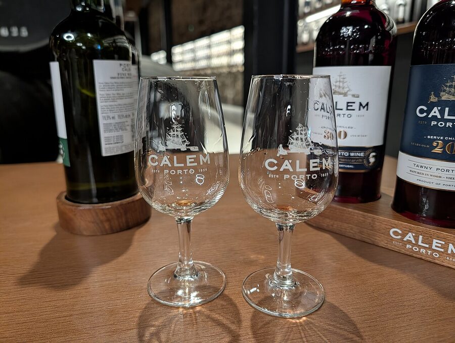 A walkway between rows of port wine barrels at Cálem