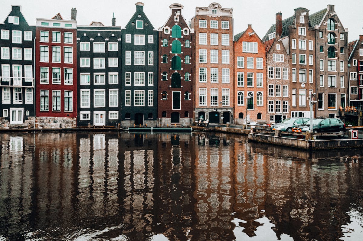 Amsterdam canal houses reflecting on serene waters
