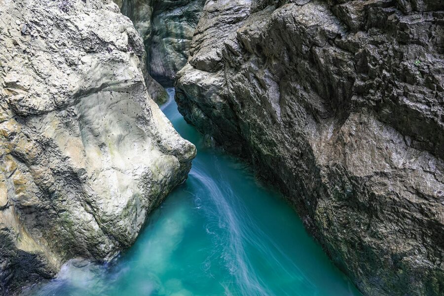 Canyon with turquoise waters flowing between rugged cliff walls