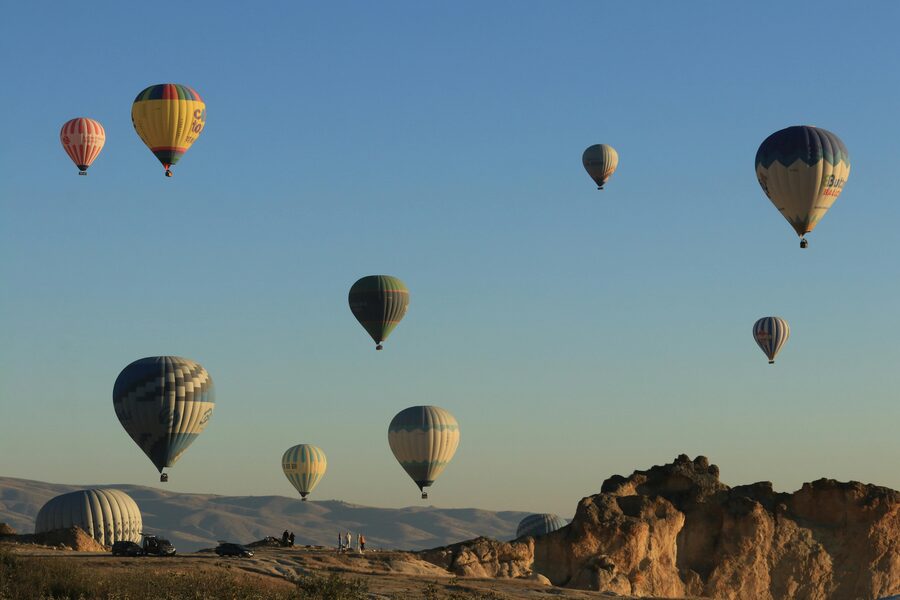 Hot air balloons rising in a field