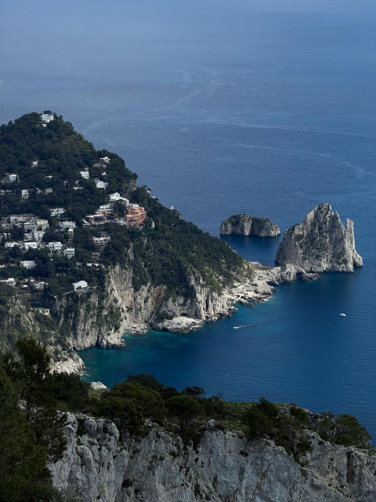 Aerial view of Capri island coastline with dramatic cliffs and turquoise Mediterranean water