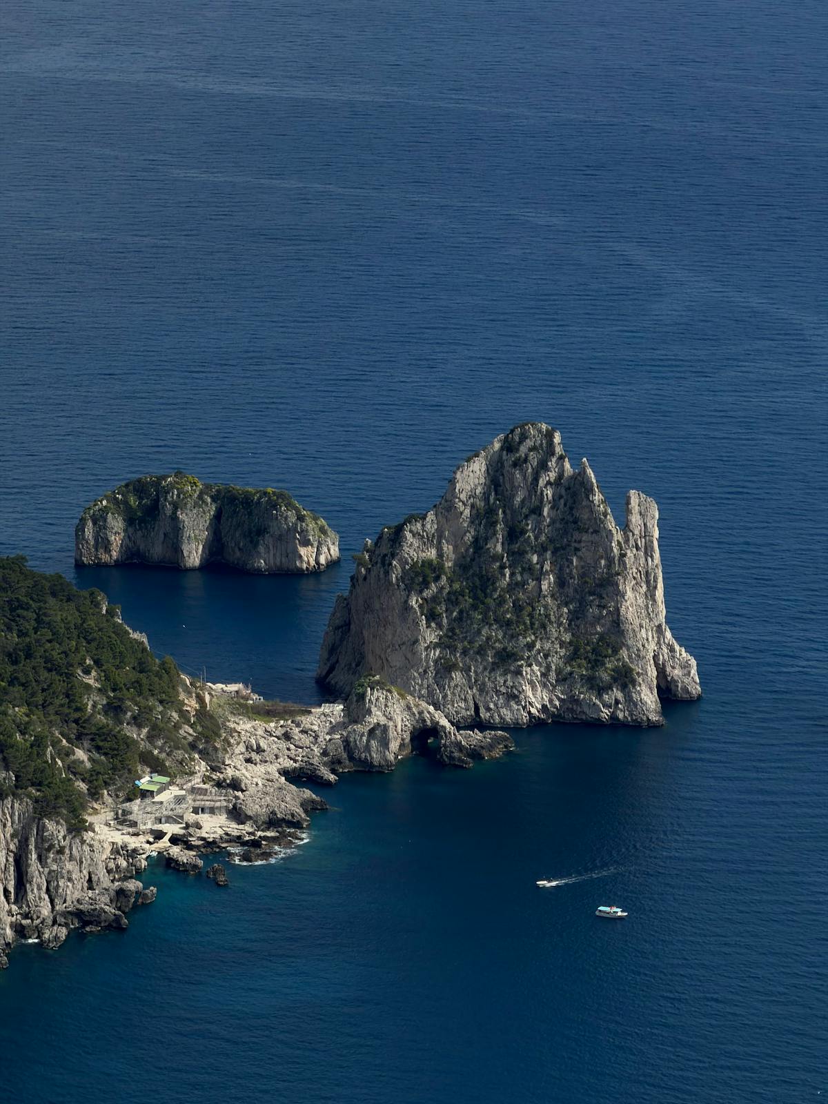Aerial view of the iconic Faraglioni rock formations off the coast of Capri Italy
