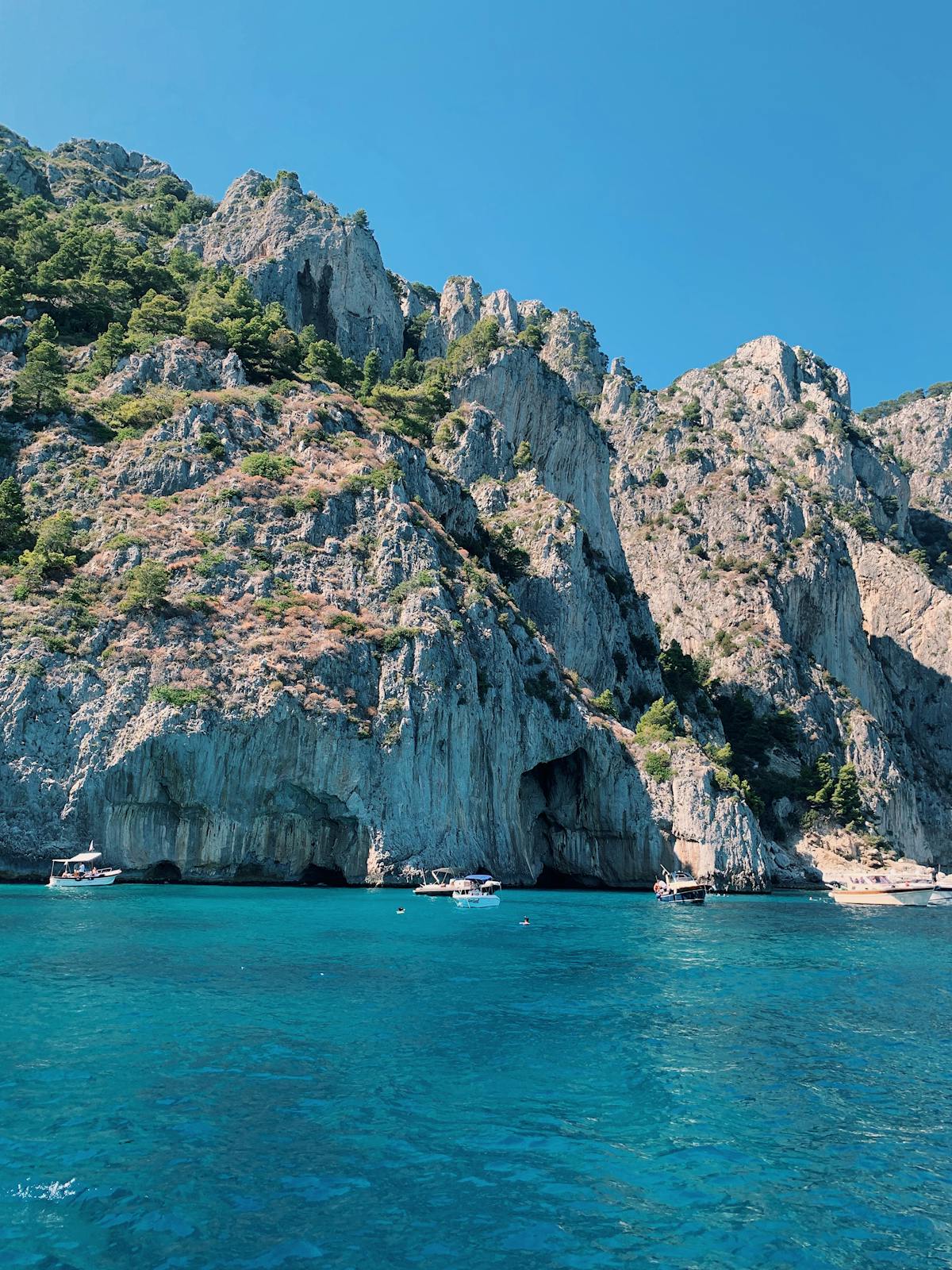 Hills and clear blue water along the coastline of Capri island
