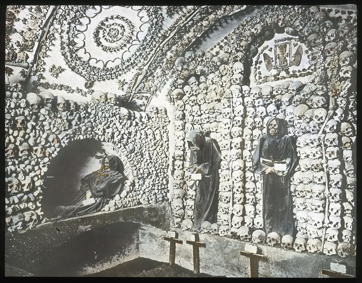 Full skeleton figures surrounded by bone decorations in the Capuchin Crypt Rome