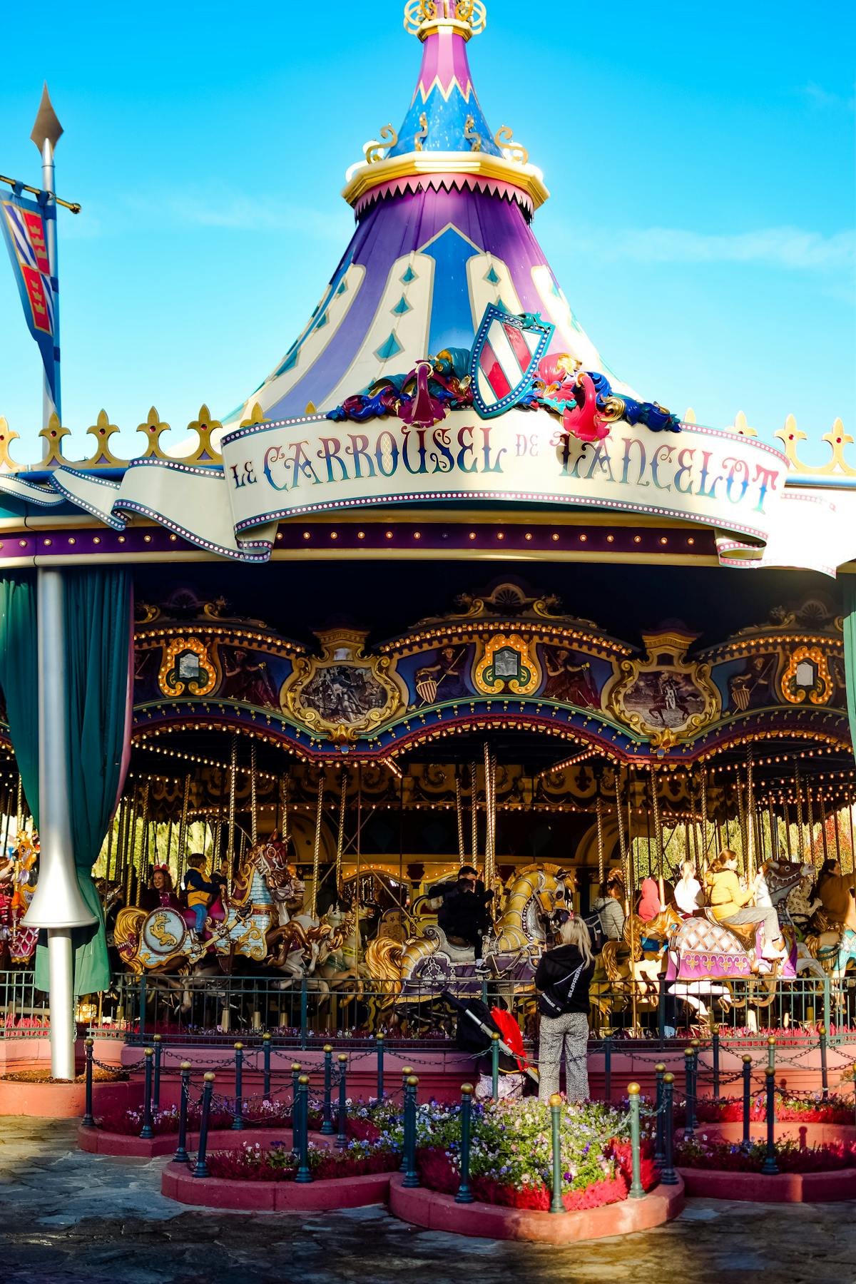 The colorful Le Carrousel de Lancelot at Disneyland Paris on a sunny day