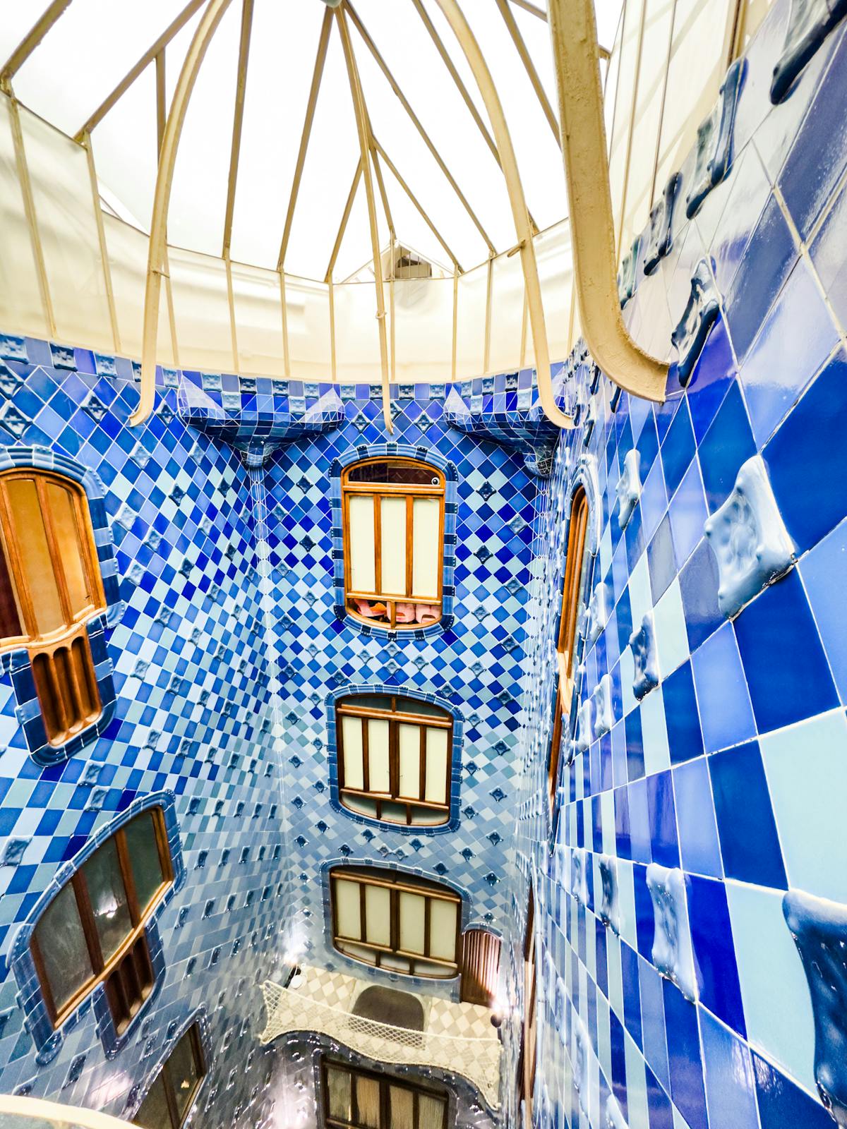 Blue ceramic tiles inside Casa Batllo light well showing the graduated colour tones from dark at the top to pale at the bottom