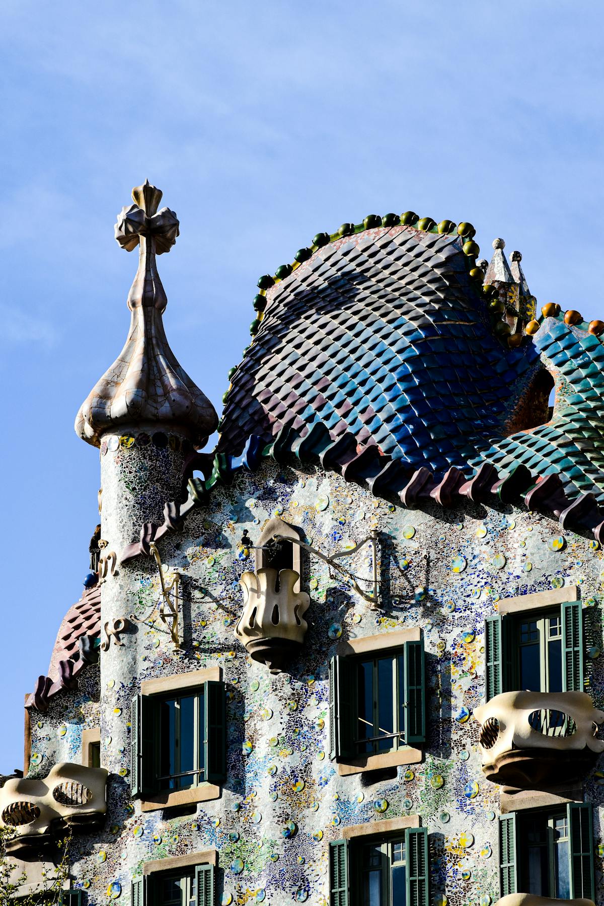 Architectural detail of Casa Batllo showing the intricate organic curves and ceramic work designed by Gaudi