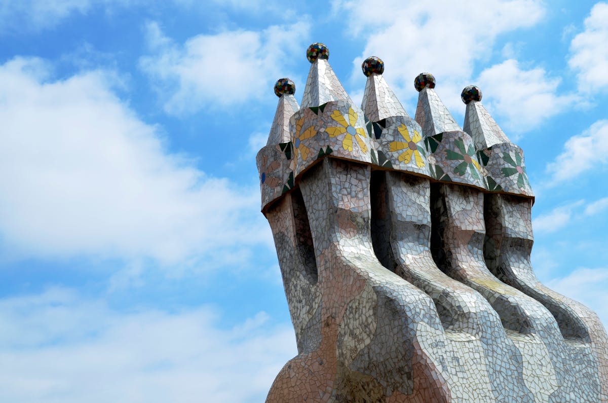 The ornate chimneys on the Casa Batllo rooftop covered in colourful ceramic tile fragments