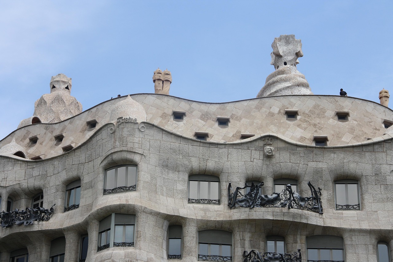 Front view of Casa Mila La Pedrera in Barcelona showing the curved stone exterior and street level entrance