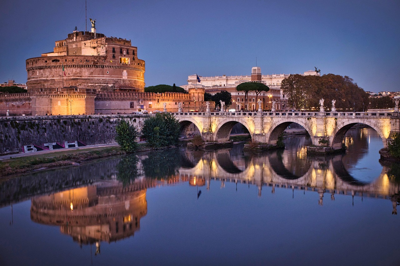 Castel Sant'Angelo glowing at blue hour with the Tiber River in Rome