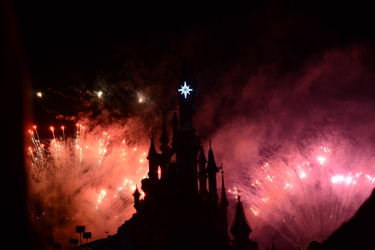 Disneyland Paris castle illuminated at night with fireworks