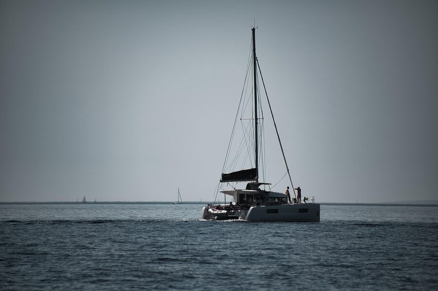 Catamaran sailing on deep blue ocean waters