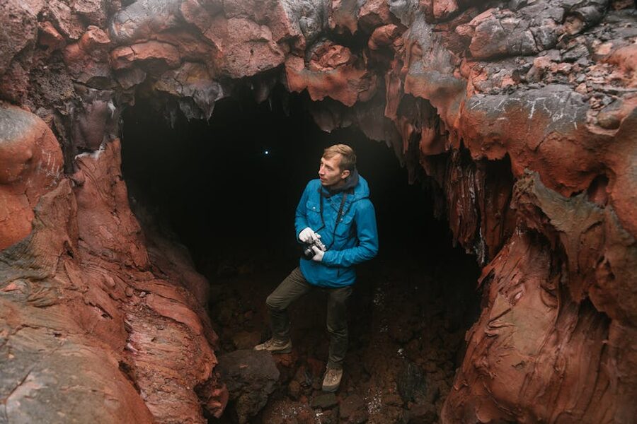 Adventure explorer at cave entrance