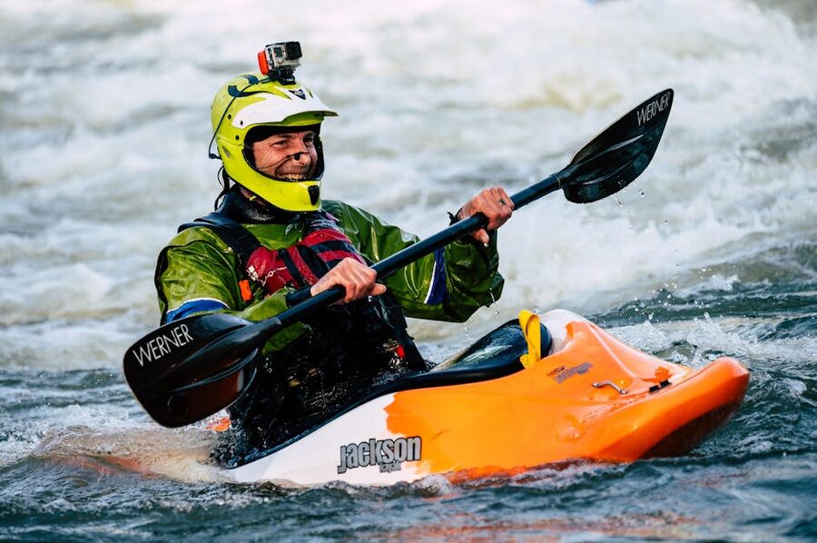 Adventurous kayaker smiling whitewater rapids
