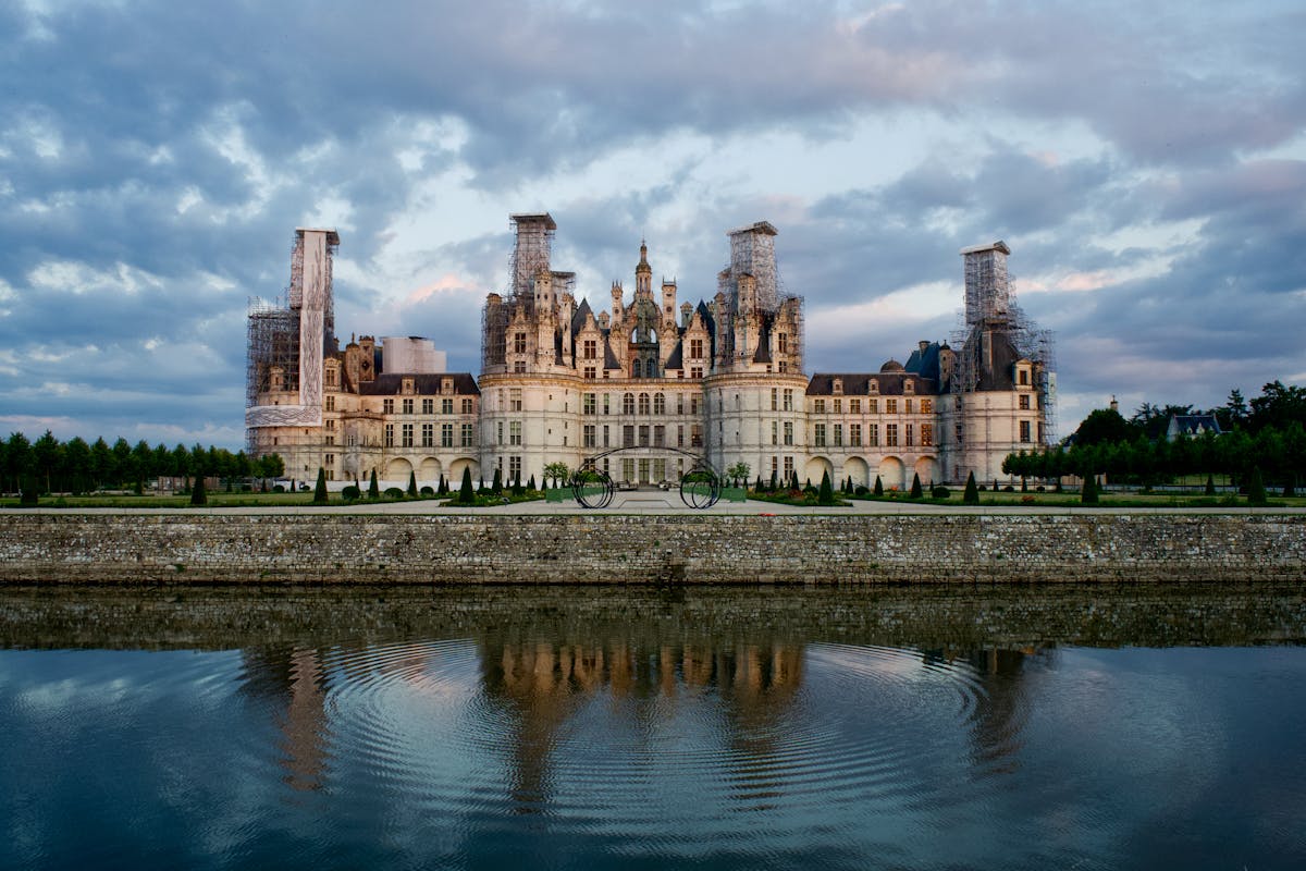 Chateau de Chambord with dramatic sky and water reflection