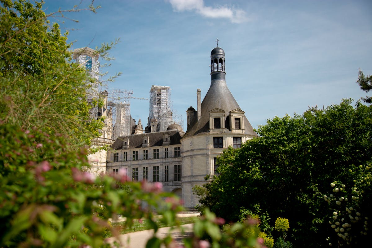 Chateau de Chambord with blooming flowers in the garden