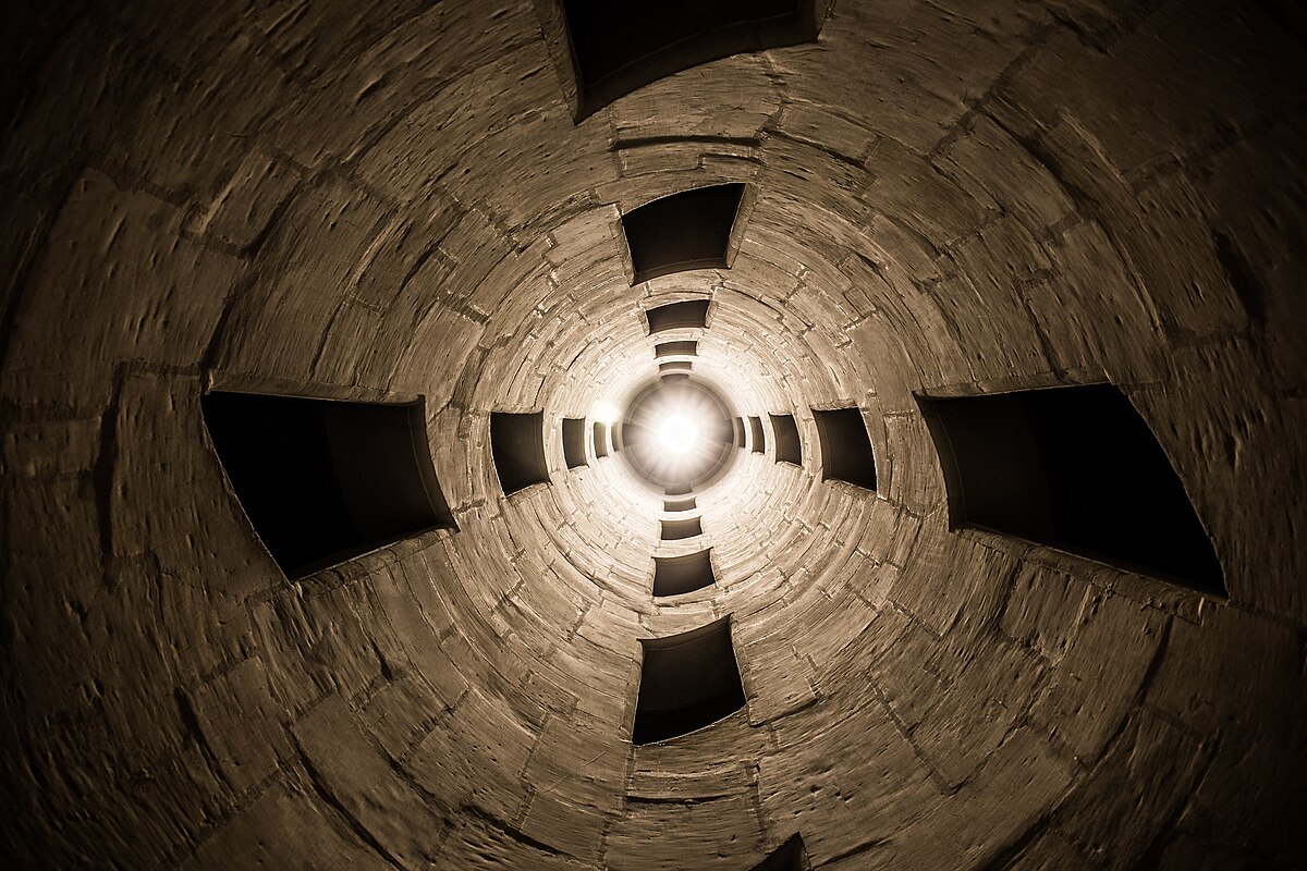 Interior view of the Chambord central staircase from below showing Renaissance stonework