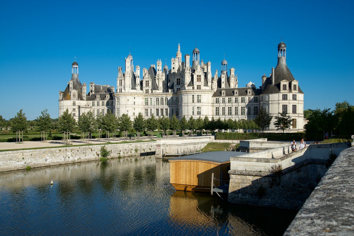 Chateau de Chambord in summer landscape with surrounding gardens