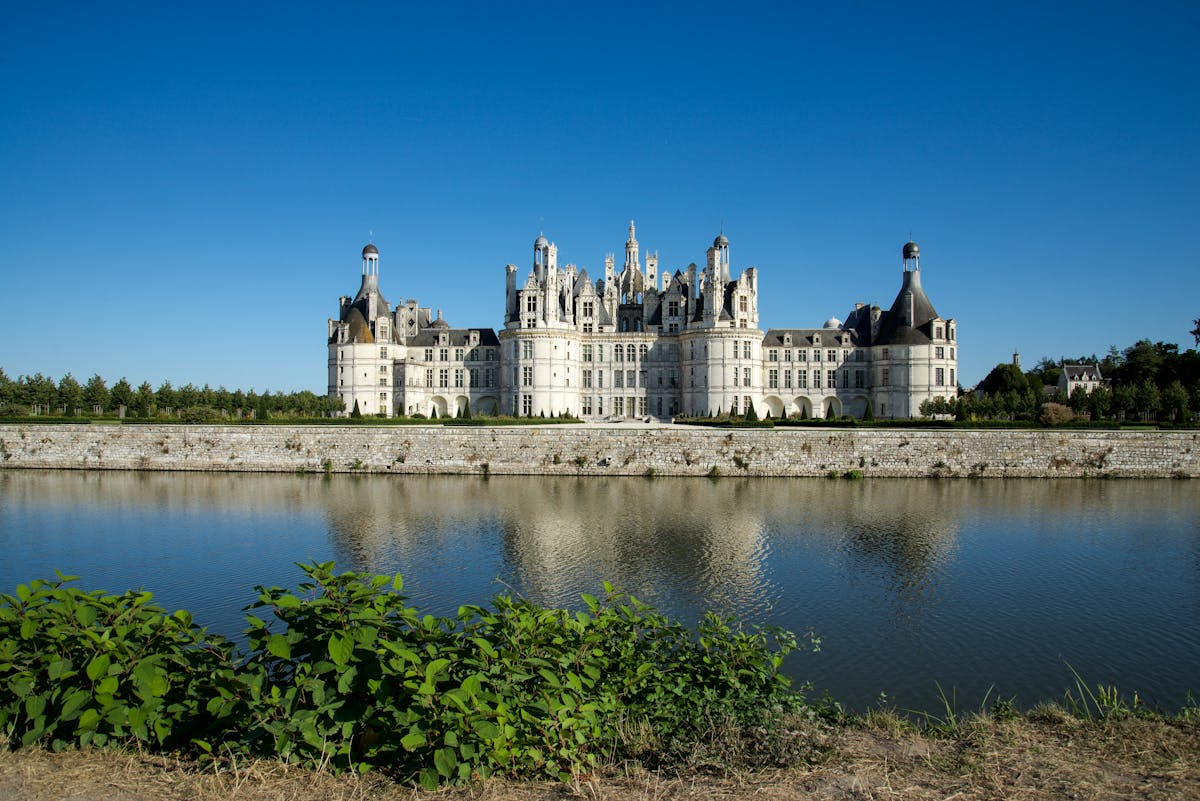 Chateau de Chambord reflected in calm water with Renaissance architecture visible