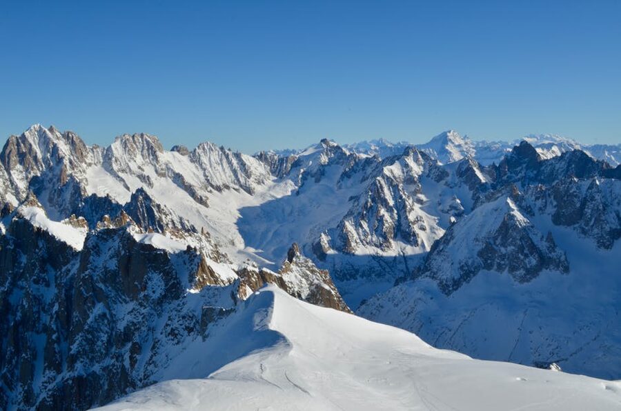 Chamonix mountains covered in snow under clear blue sky