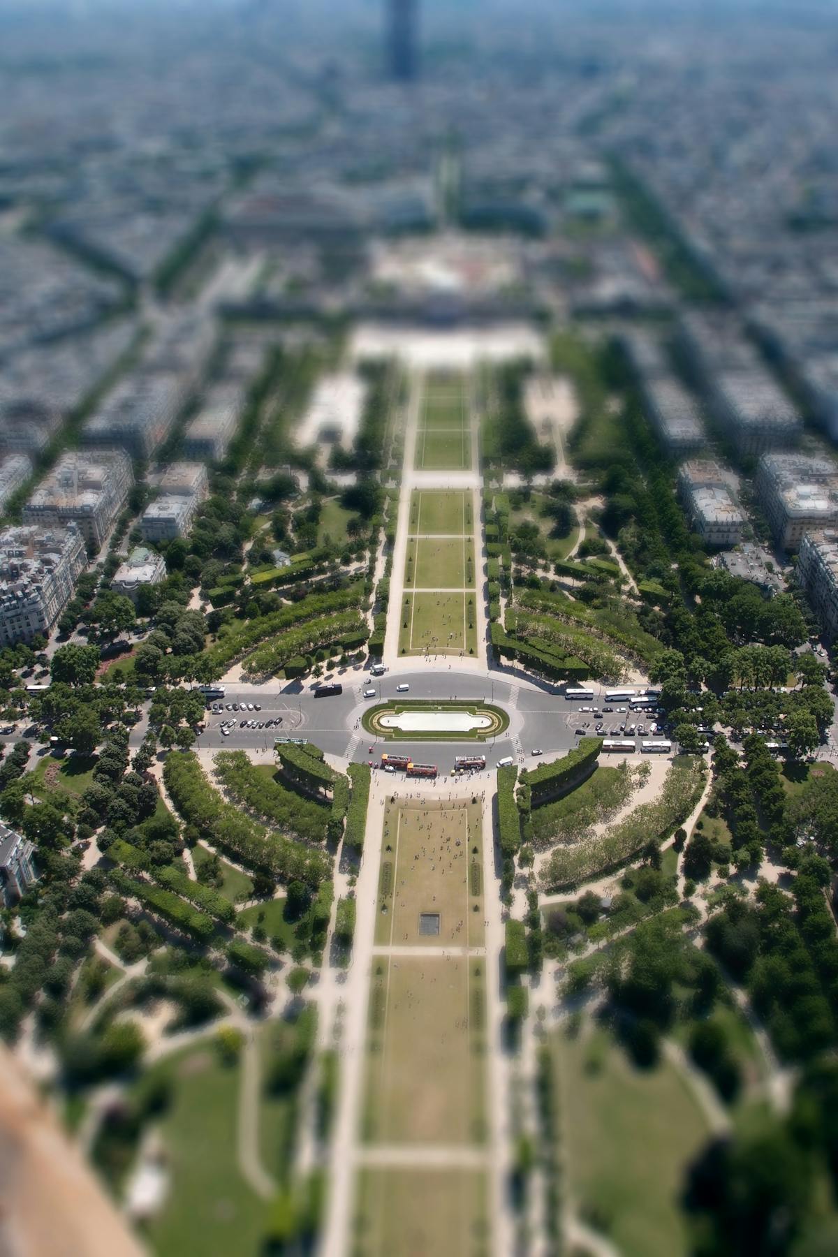 Aerial view of the Champ de Mars gardens stretching toward the Eiffel Tower