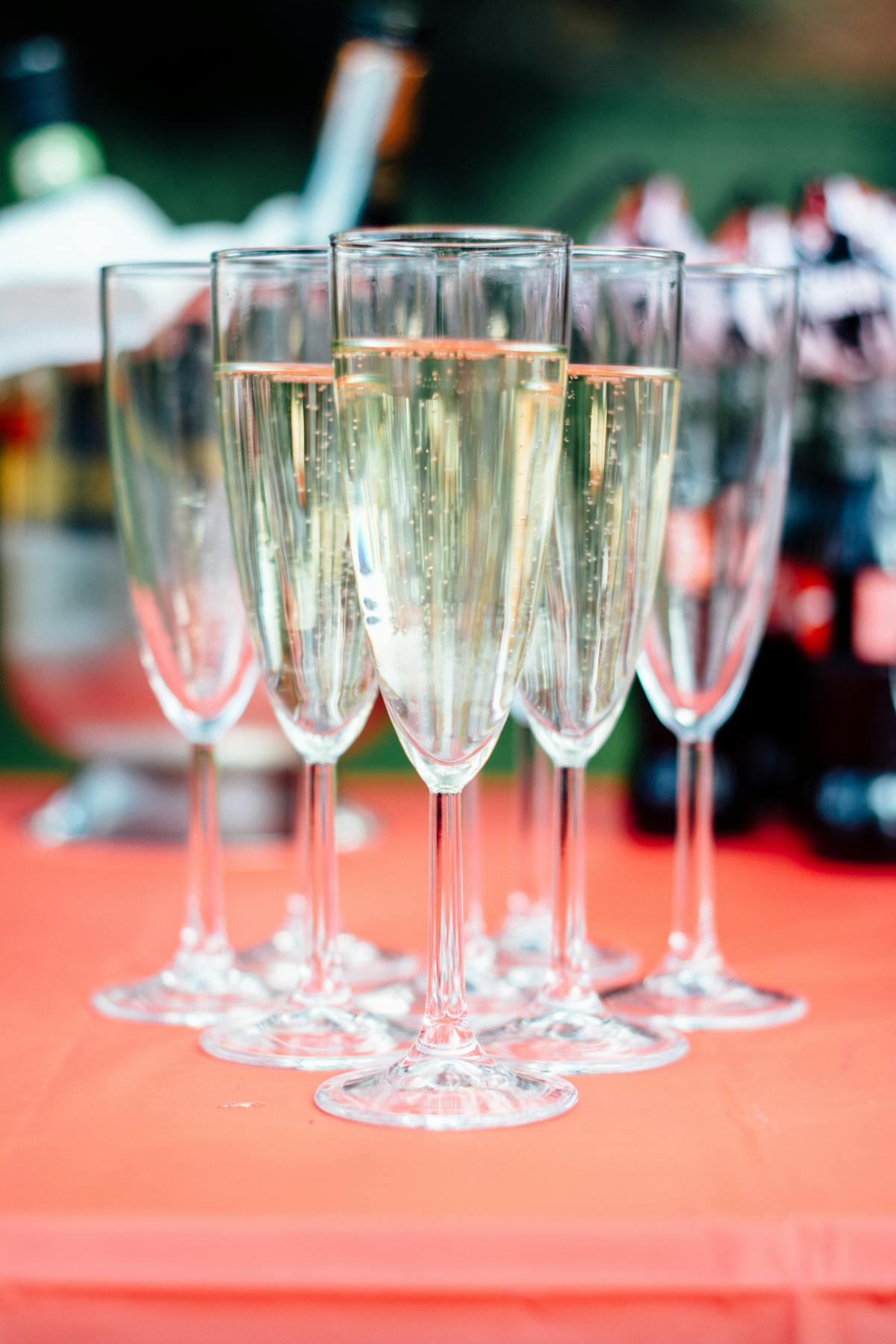 Two champagne flutes filled with bubbly sitting on an elegantly set table