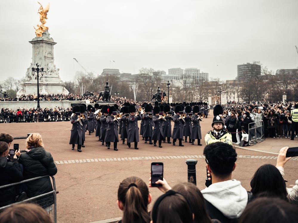 Soldiers in uniform marching during the Changing of the Guard ceremony at Buckingham Palace London