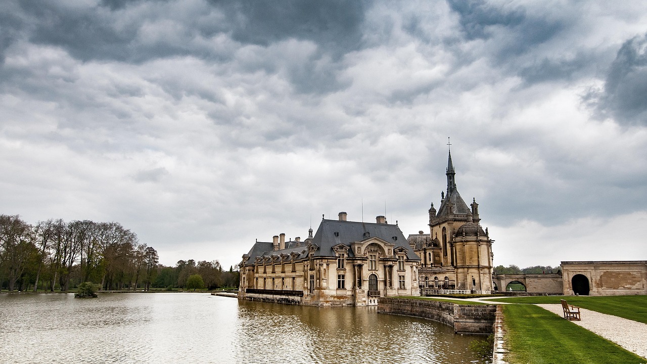 Chateau de Chantilly and its moat from the parkland
