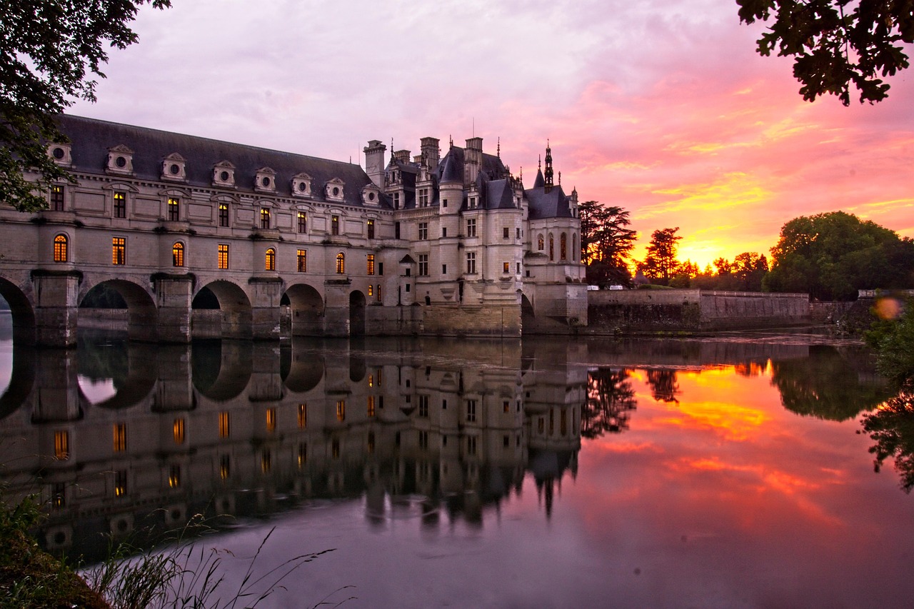 Château de Chenonceau at sunset with golden light on the river