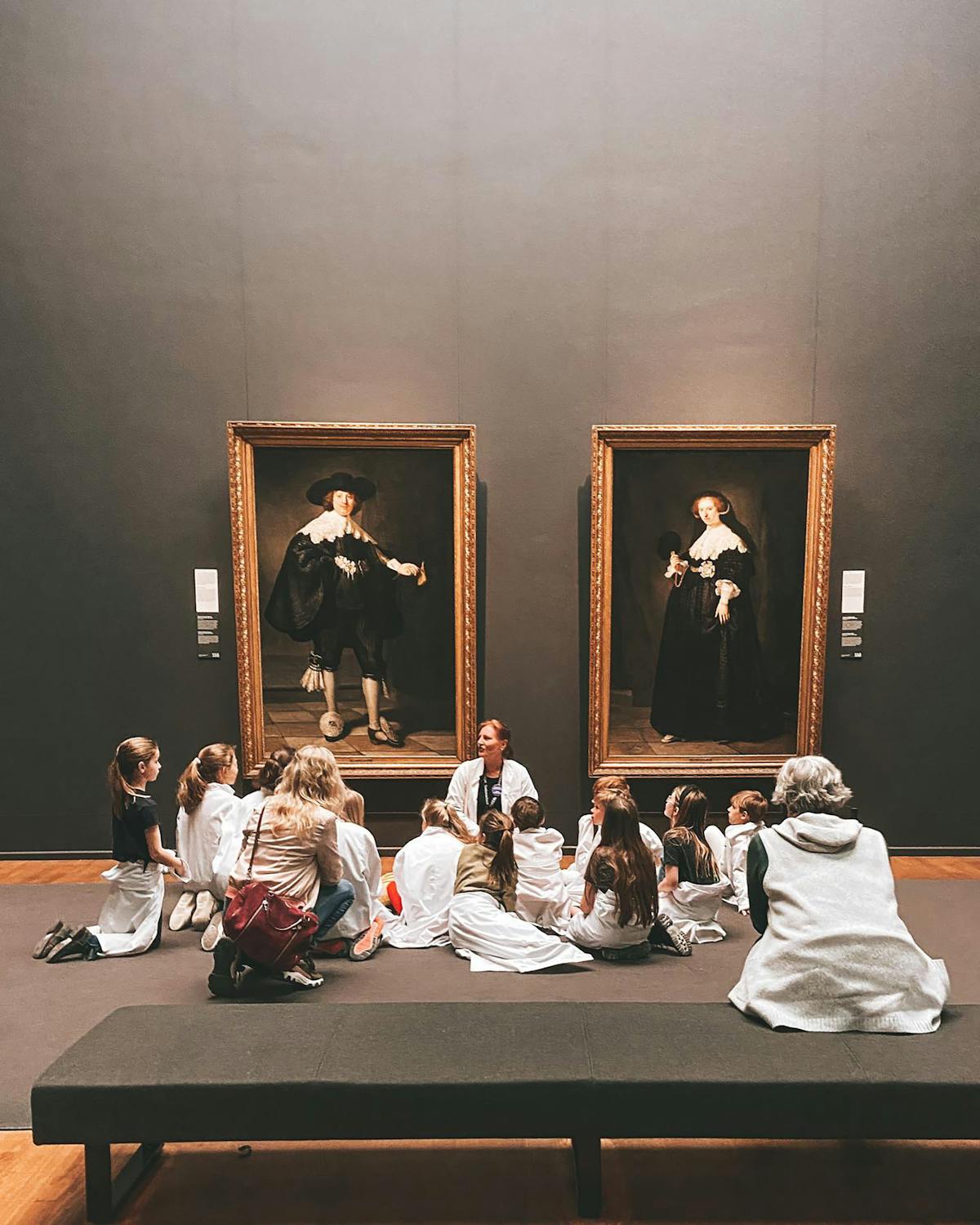 Children in an educational group viewing Rembrandt paintings at the Rijksmuseum