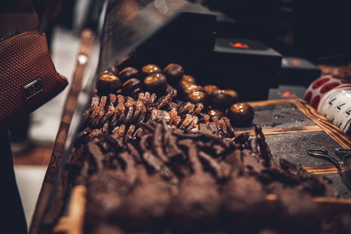 Variety of artisanal chocolates on display in dark moody setting