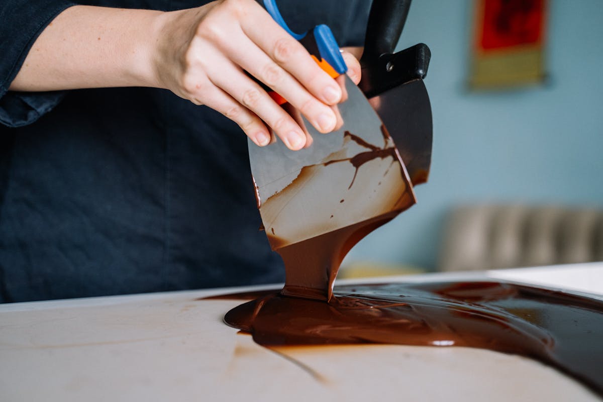 Close-up of chocolate being tempered by hand