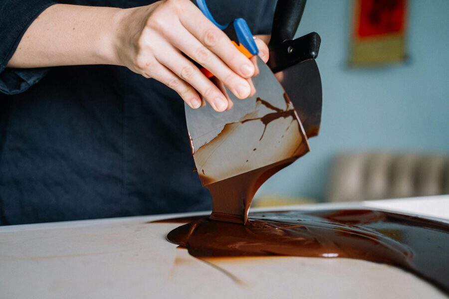 Chocolatier tempering chocolate by hand