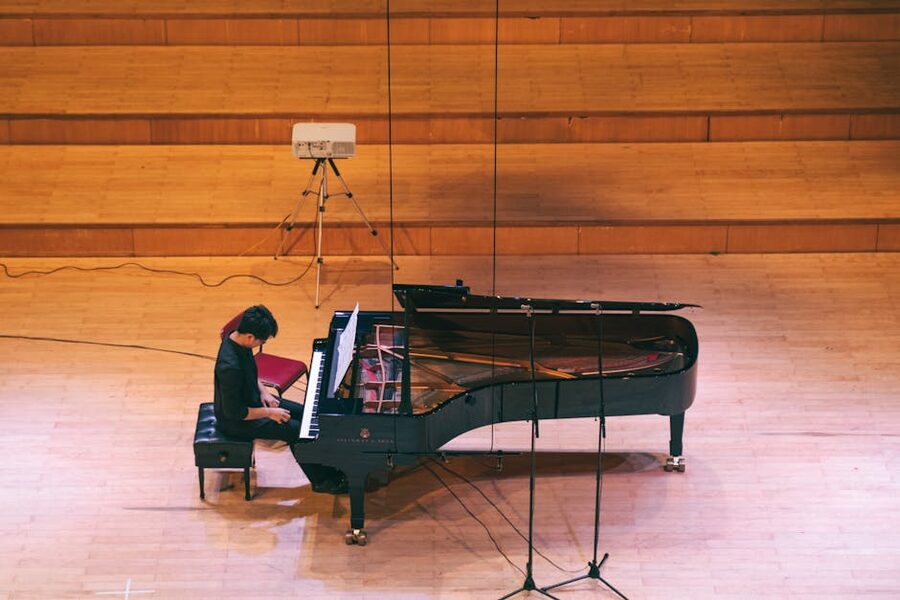 Musician at grand piano in concert hall